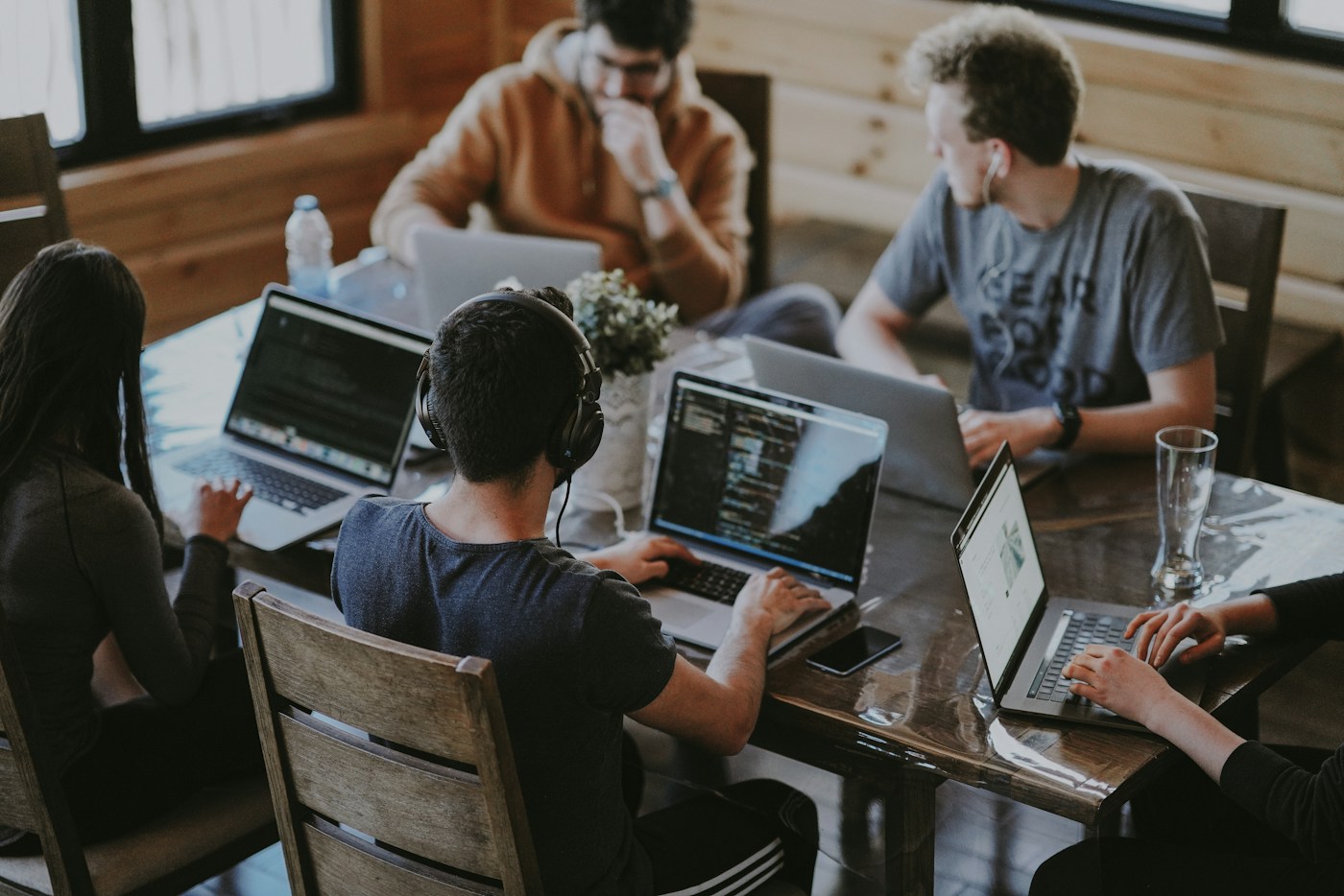People collaborating around laptops in a professional workspace